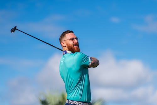 Man swinging a golf ball